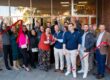 A group of lighting agency team members cut a red ribbon to commemorate expansion into the Savannah, Georgia territory